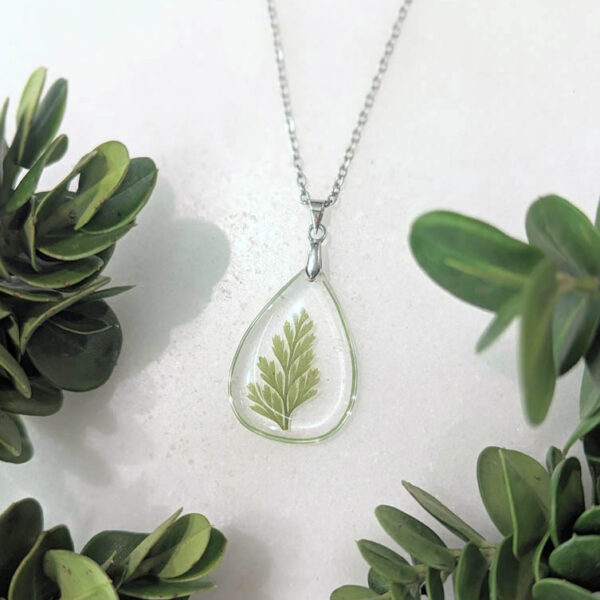 frameless teardrop necklace with a real green preserved wildflower foliage inside