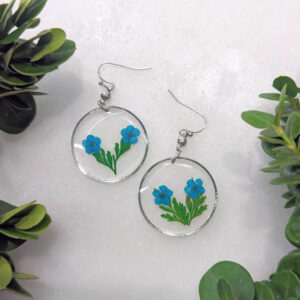 blue bouquet earrings - large dainty circle frames with a bouquet of real pressed flower and foliage insidethe window