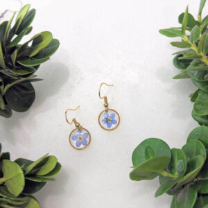 dainty gold dangle earrings with real blue forget-me-not flowers inside